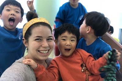a young learner ESL teacher with her students